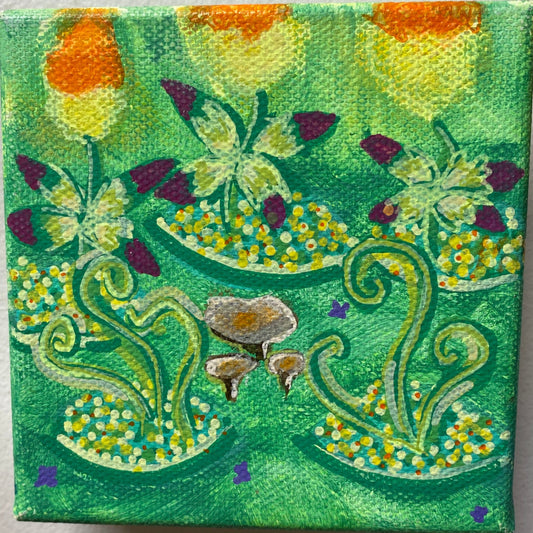 Small square canvas with a colorful floral design on a white wall.